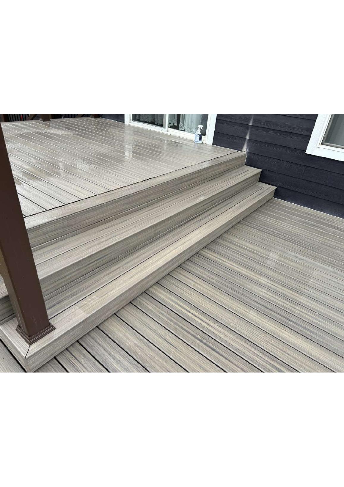 Wood deck and steps leading to a home's sliding door